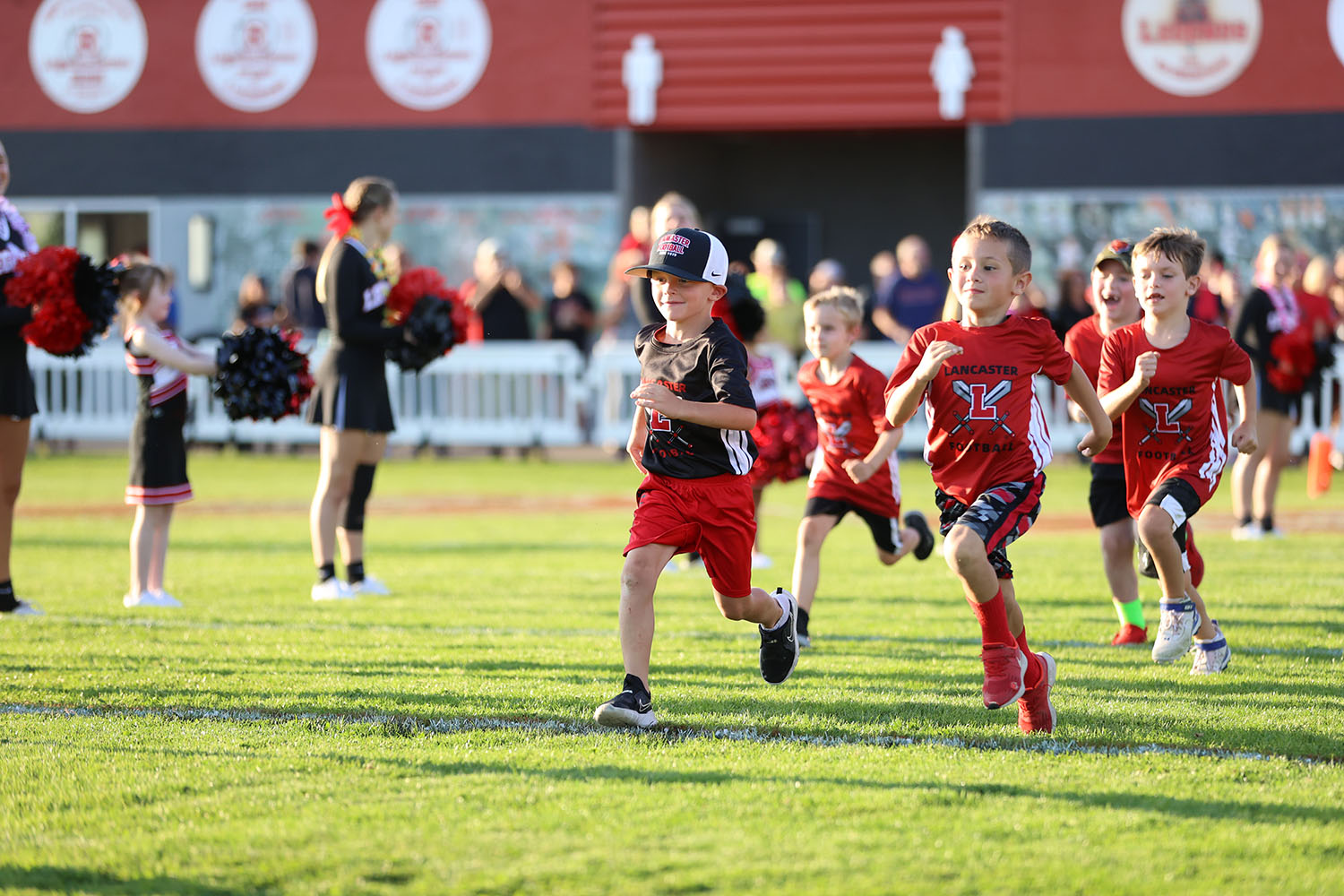 Lancaster youth football players running on Foyle-Kling Field