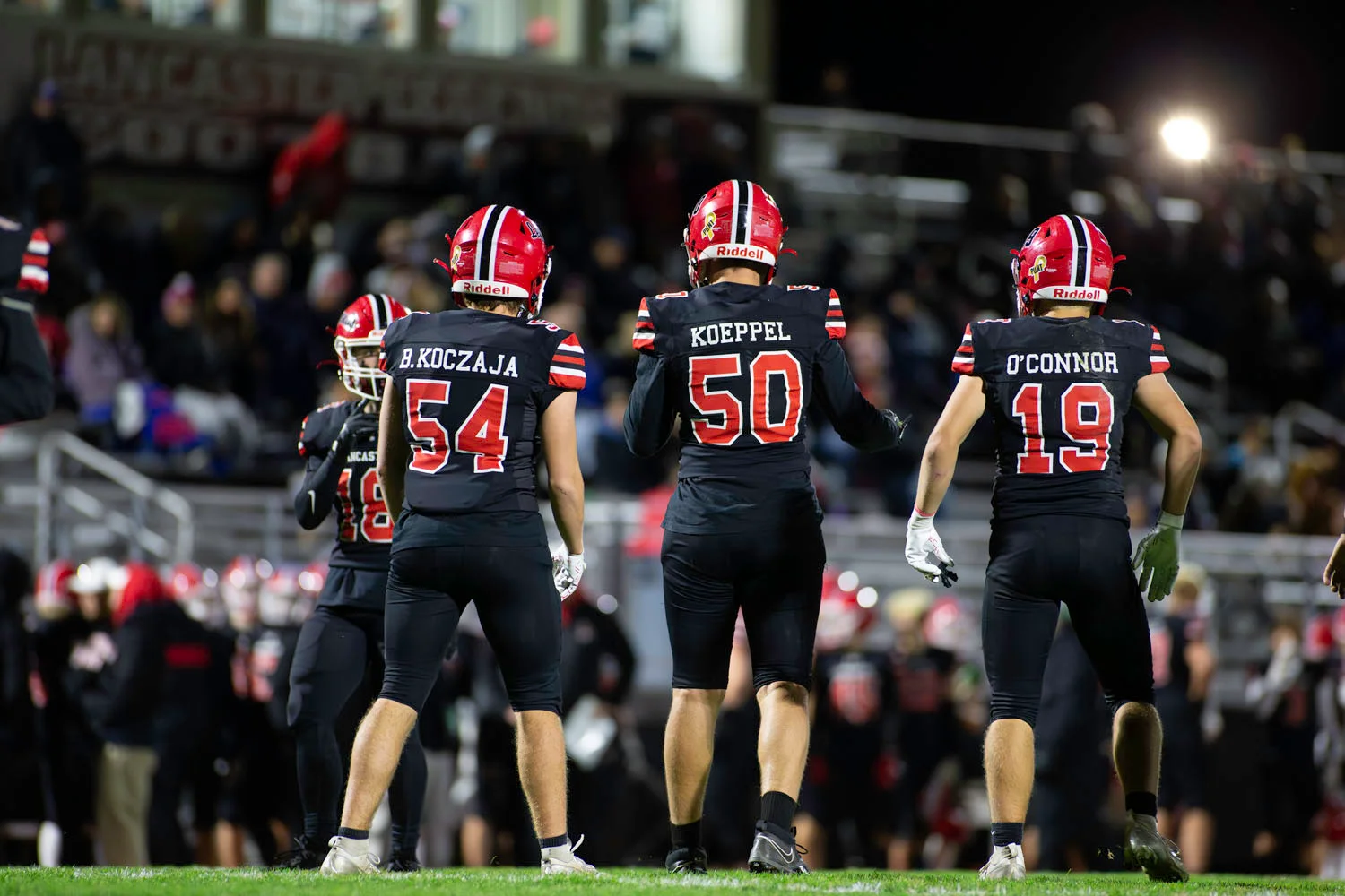 Teammates on the field against Lockport