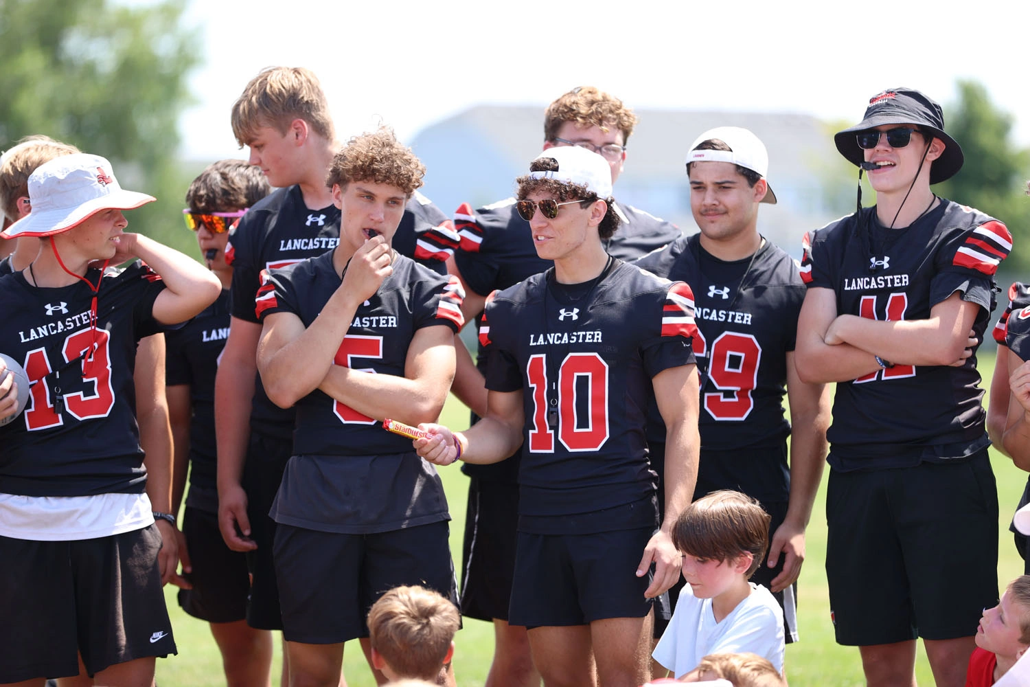 Varsity players calling on campers of the day