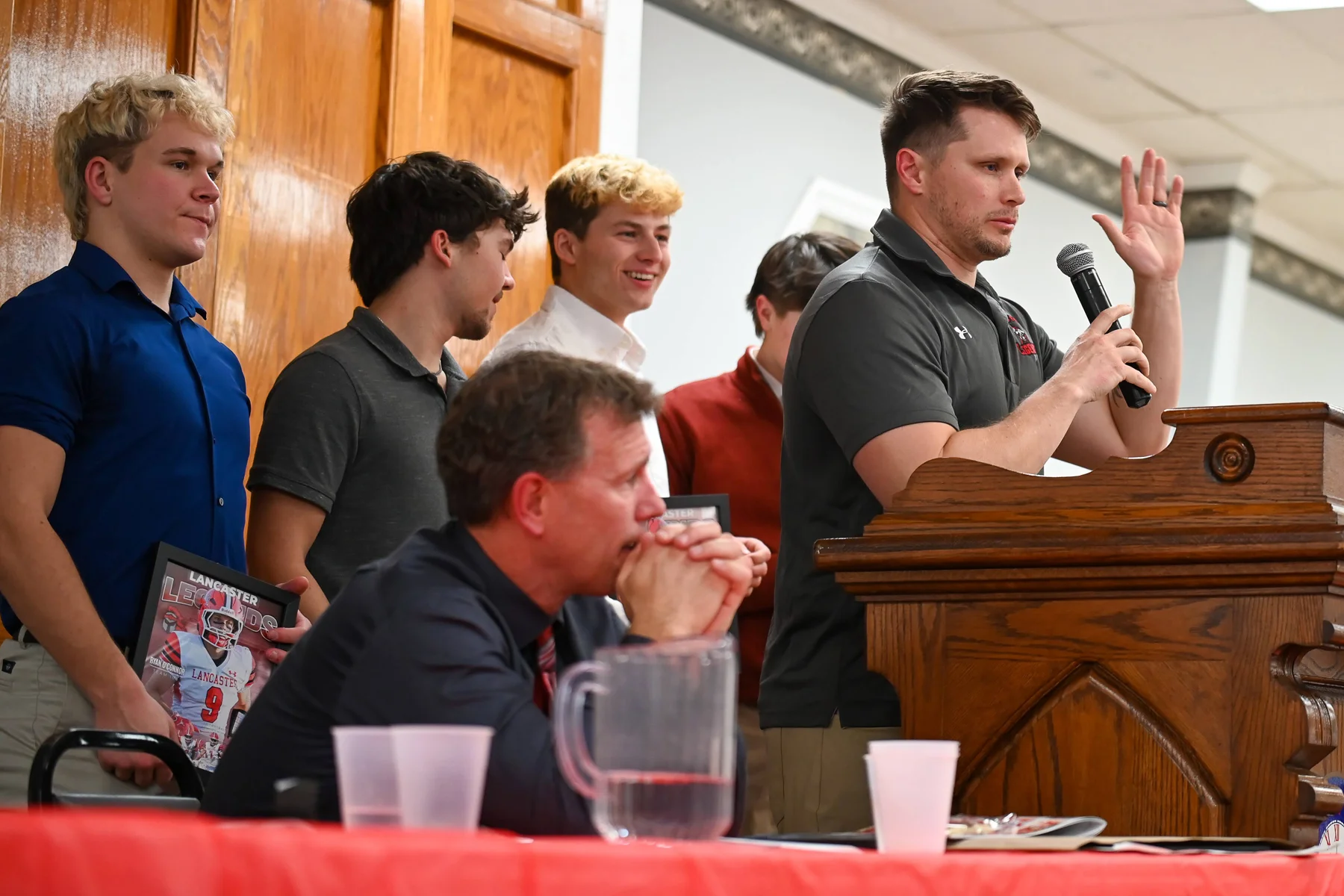 Coach Amato speaking with players behind him