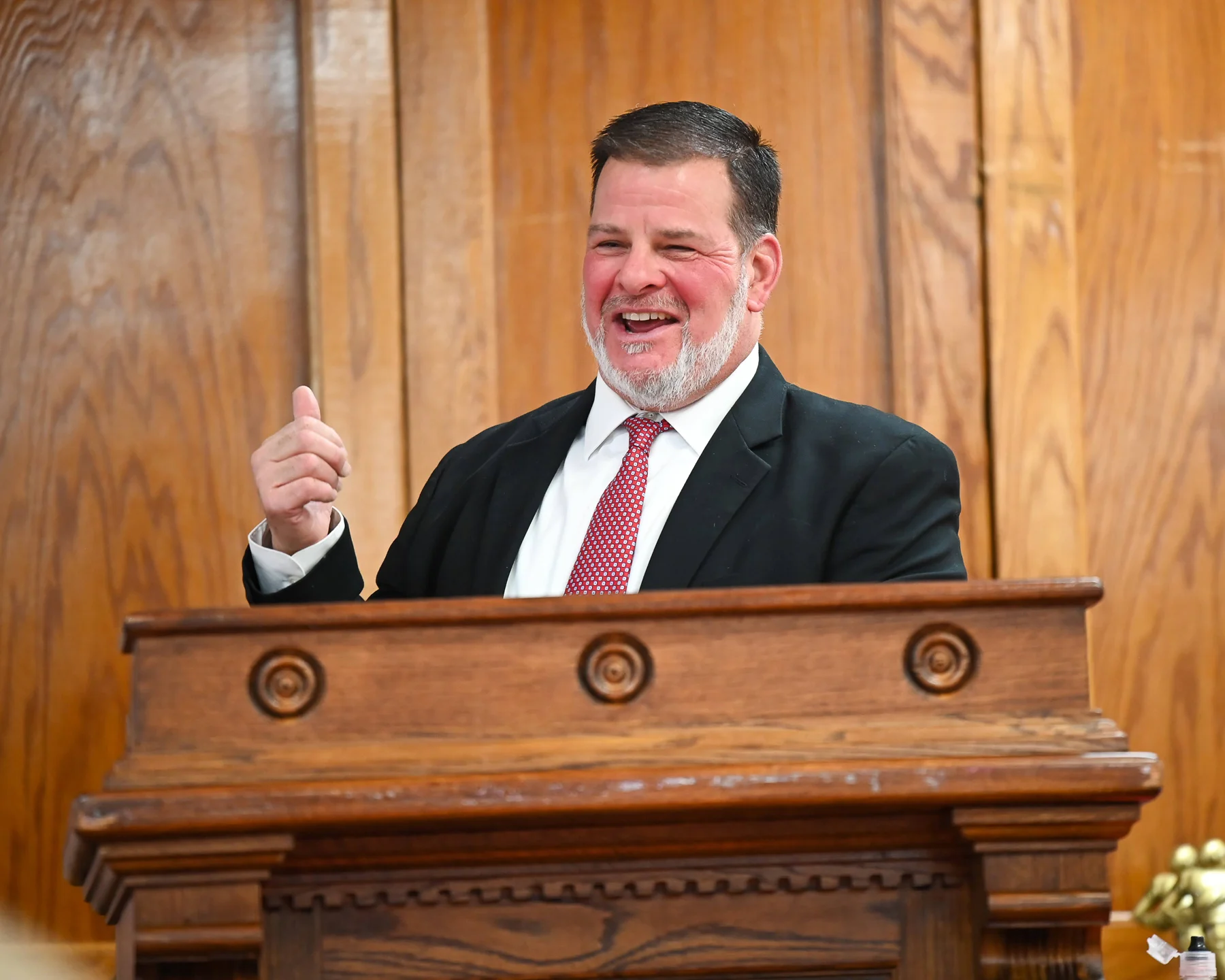 Coach Wild speaking and all smiles at the banquet