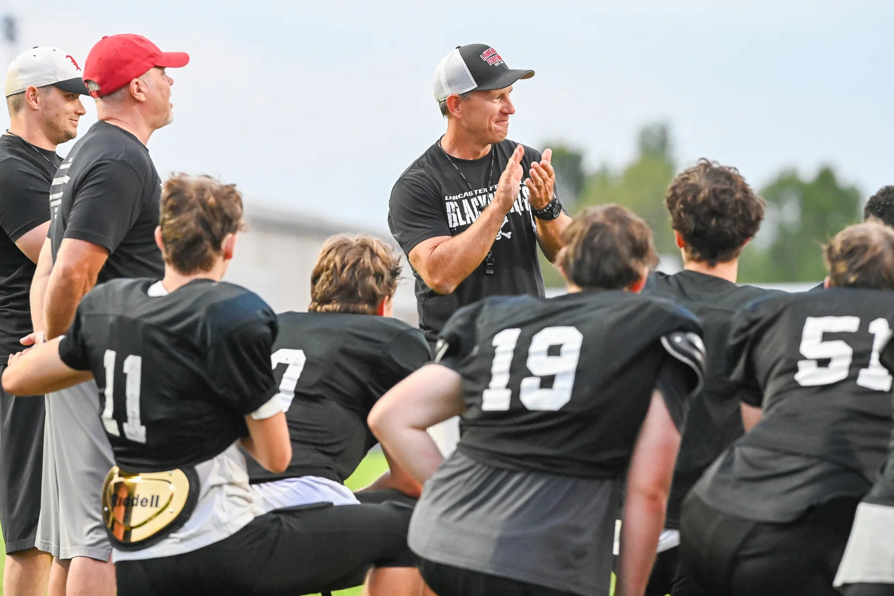 Coach Mansell clapping at the end of the scrimmage