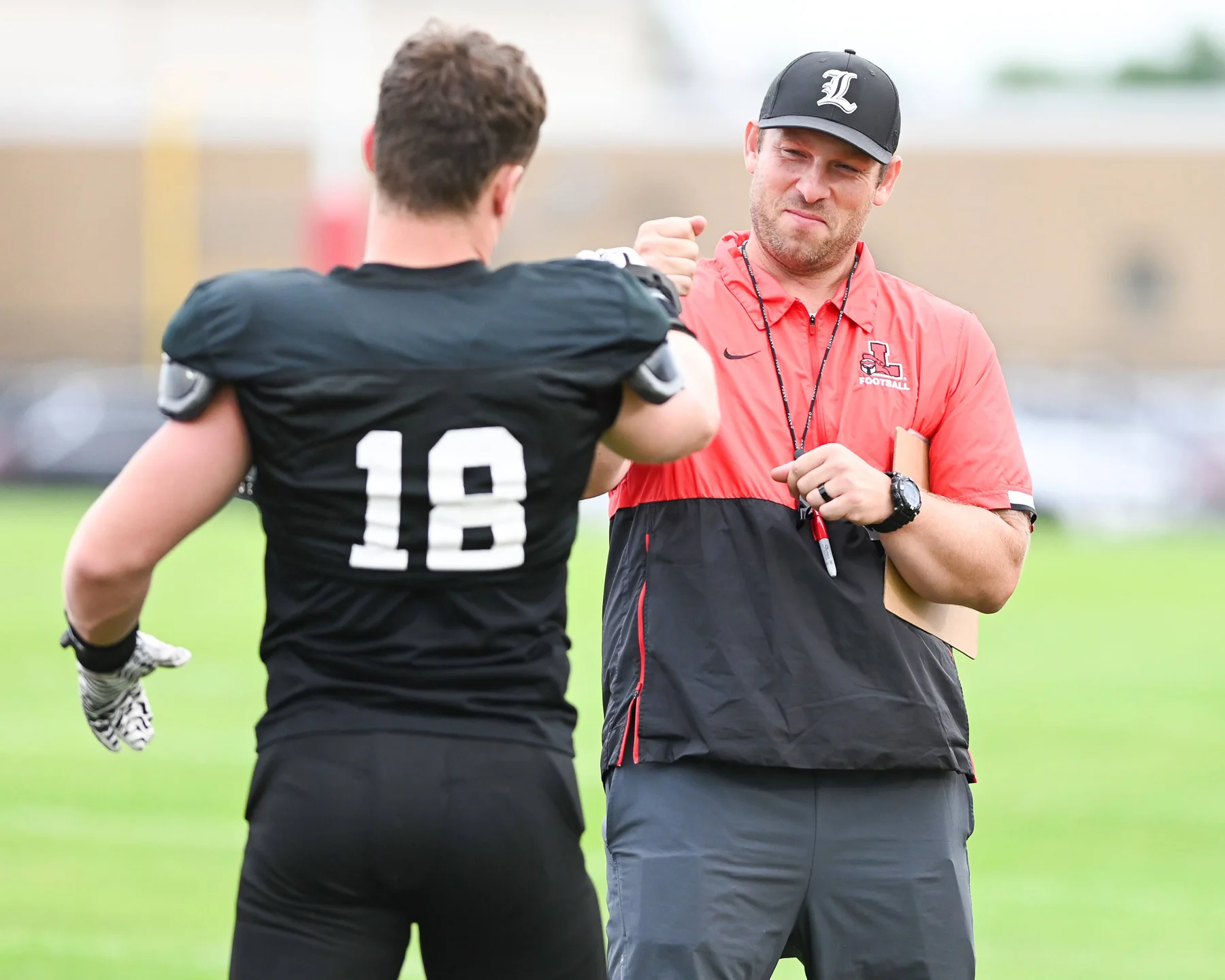 Coach Rupp fist bumping a player