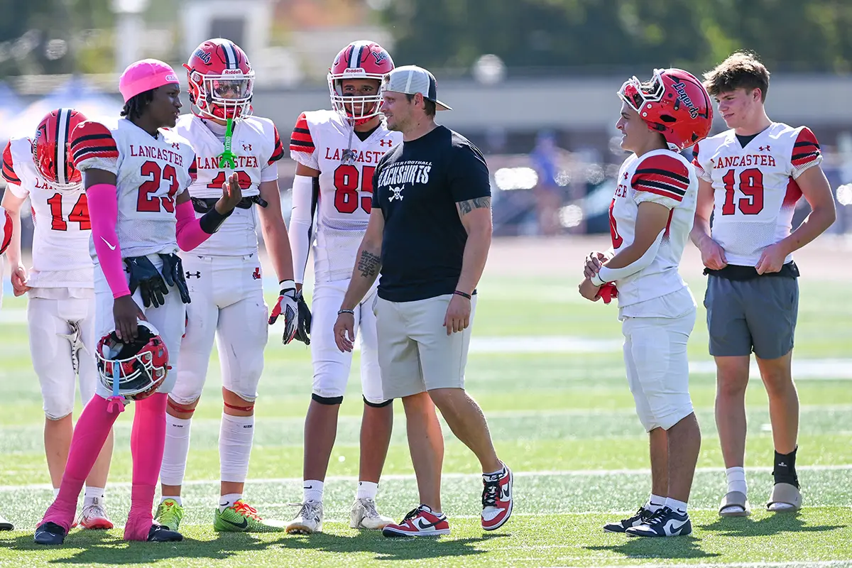 Lancaster players talking with coach prior to the game