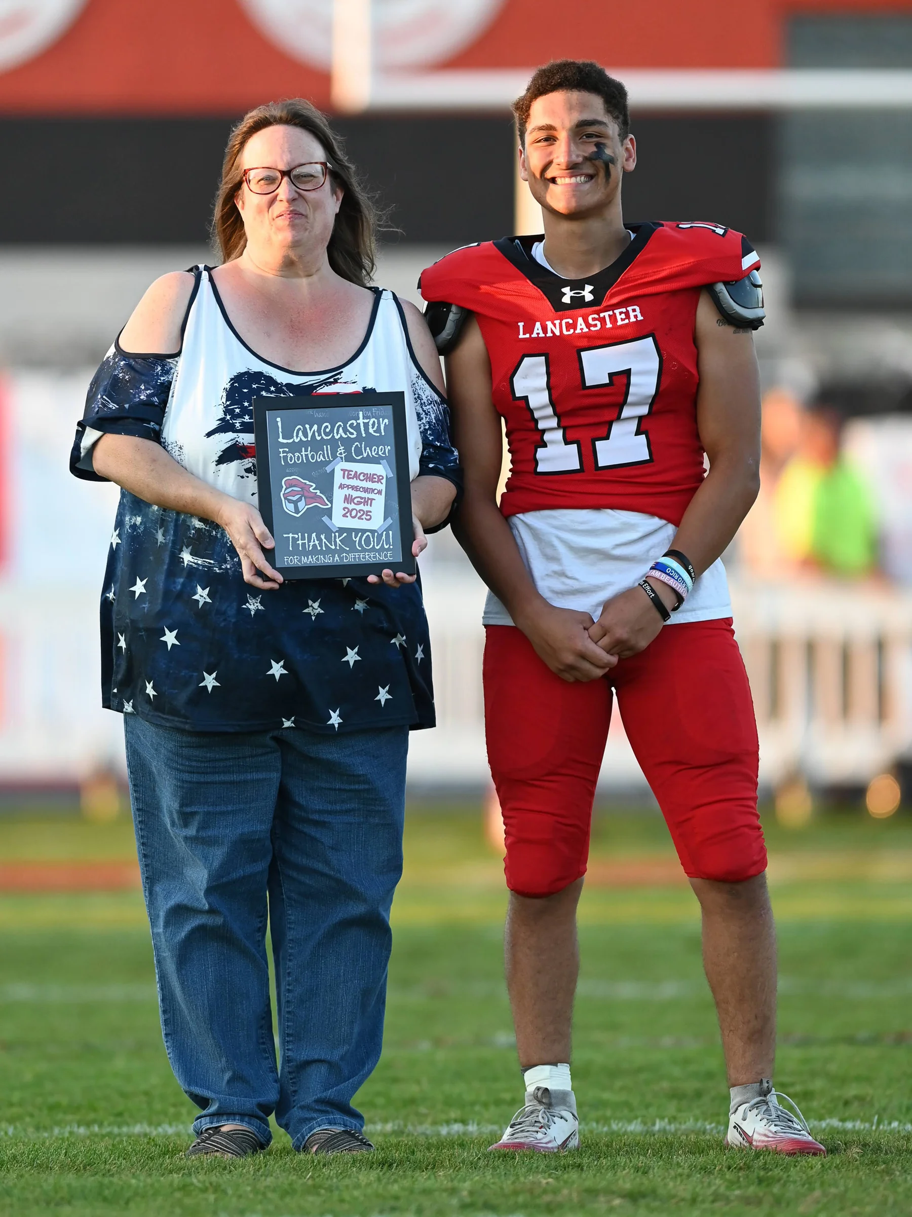 Michael smiling along with the teacher on Teacher Appreciation Night