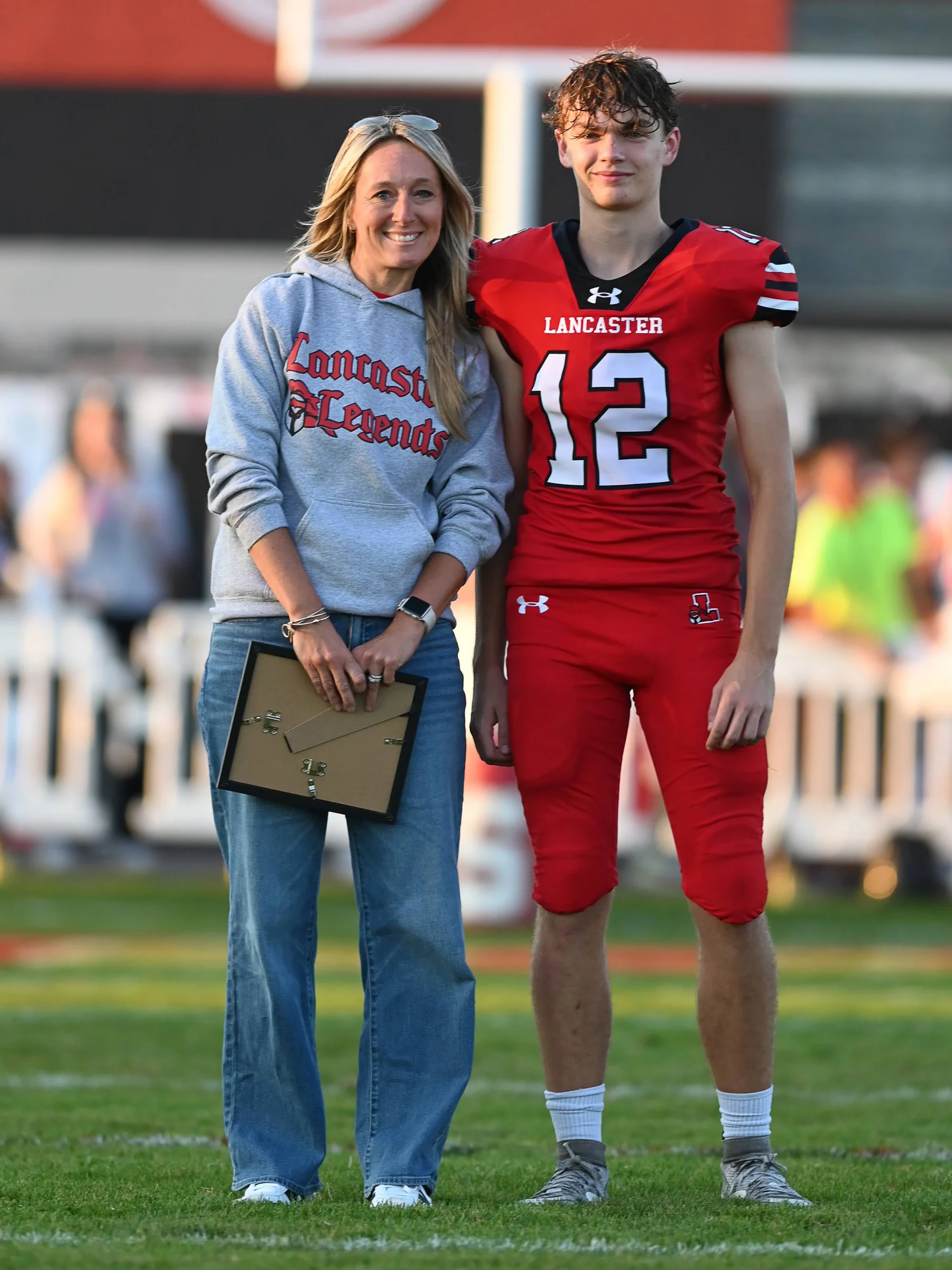 Tristan standing next to his favorite teacher