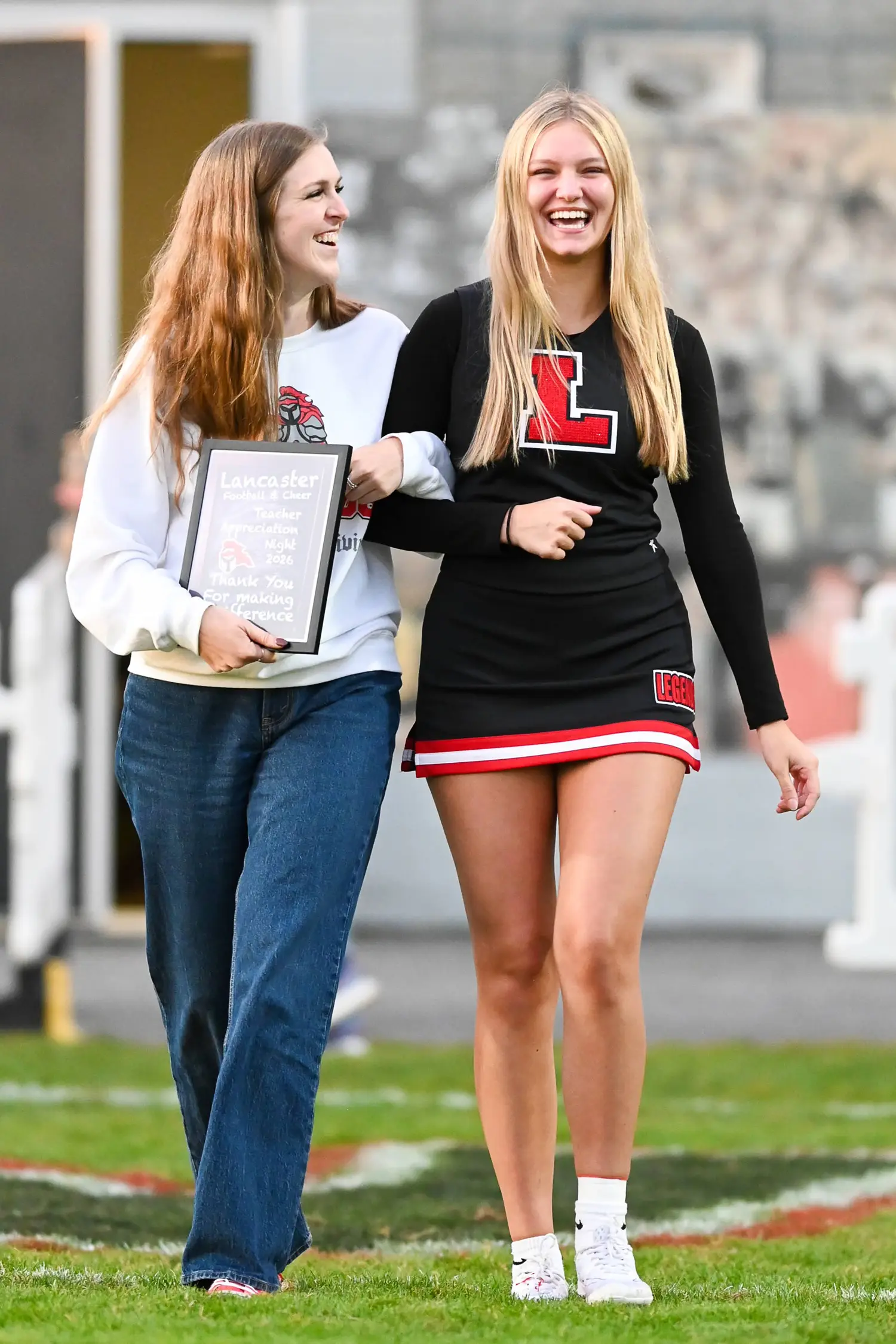 Smiling Teacher and Cheerleader on Teacher Appreciation Night
